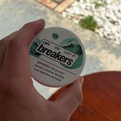 Hand holding a LUCY Breakers Mint can